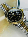 Luxury men's two-tone watch with black dial, diamond hour markers, and gold bezel on marble surface