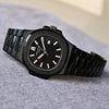 Luxury black men’s watch with stainless steel band and modern design on gray surface