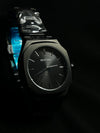 Men’s black BESTWIN watch with minimalist dial and metal strap on a dark background