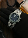 Luxury men’s stainless steel wristwatch with blue dial displayed on gloved hand, Ministry of Mens Affair