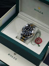 Luxury men's Rolex watch with black dial and two-tone bracelet in green display box