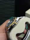 Luxury men's two-tone watch with gold bezel and black dial, showcased at Ministry of Mens Affair