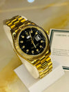Gold luxury men's watch with black dial and diamond hour markers on display at Mens Affair