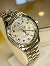 Luxury silver men's watch with diamond hour markers and day-date display on stand