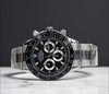Luxury men's stainless steel chronograph watch with black dial on marble surface
