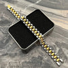 Two-tone gold and silver men's watch band on black box, premium accessory at Mens Affair