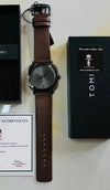 Men’s luxury TOMI watch with brown leather strap, black dial, box, and certificate of authenticity